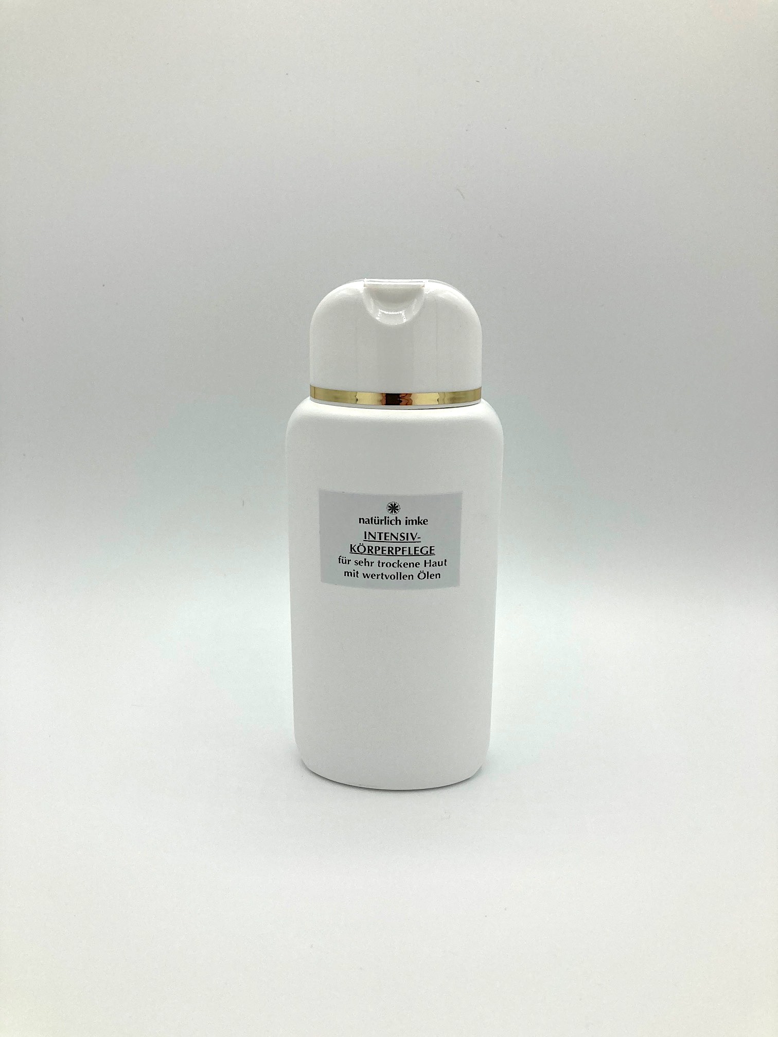 Die ovale, weiße 200ml-Lotionflasche aus HDPE mit ausklappbarem Verschluss und Goldrand.