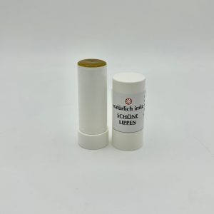 Die weiße zylindrische Lippenstifthülse enthält einen gelbbraunen Lippenstift.